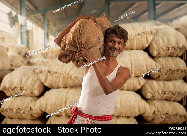 A FARMER CARRYING HIS PRODUCE