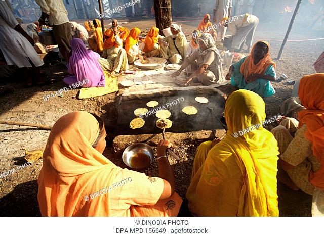 Sikh devotees making rotis wheat flour bread in community kitchen ; Sachkhand Saheb Gurudwara in Nanded ; Maharashtra ; India