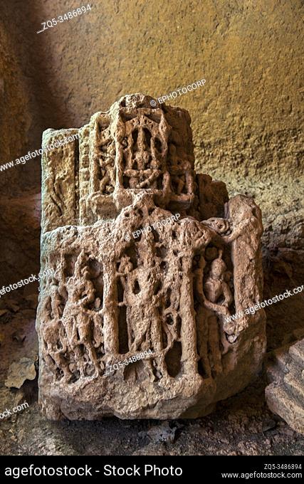 Panhale Kaji or Panhalakaji Caves, District- Sindhudurg, Maharashtra, India : A loose sculpture showing standing figures and above is a seated Goddess recently...