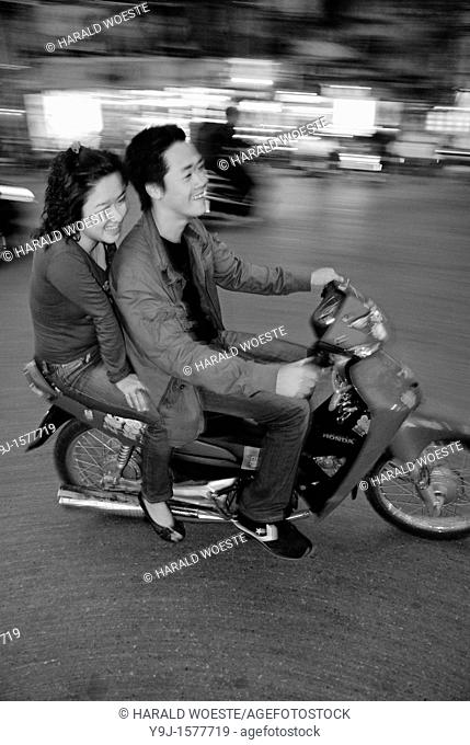 Asia, Vietnam, Hanoi  Hanoi old quarter  Young couple on motorbike rushing through the traffic