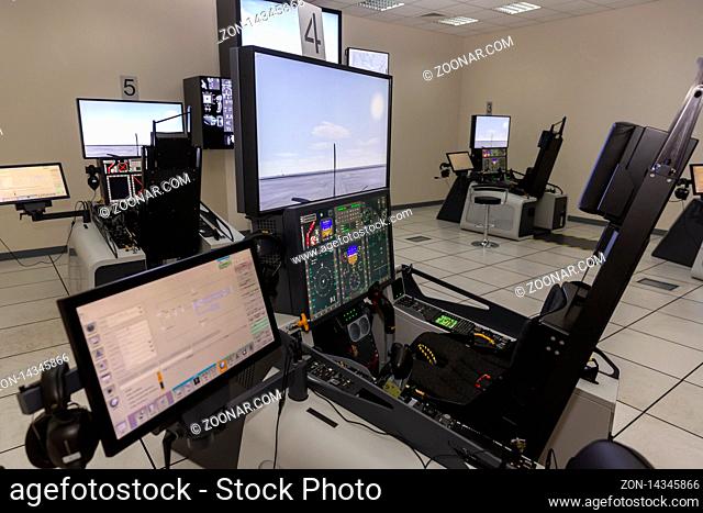 Fighter aircraft simulator training room. A flight simulator is a device that artificially re-creates aircraft flight and environment in which it flies