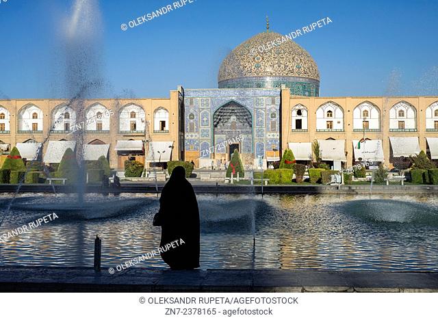Muslim woman standing in front of the mosque at the Naqsh-e Jahan Square, Esfahan, Iran