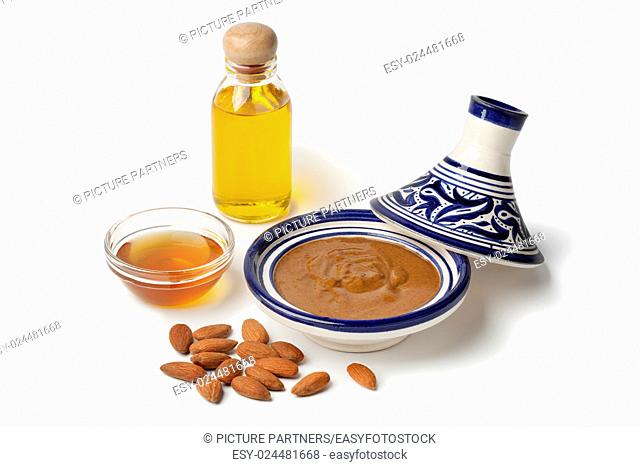 Traditional Moroccan almond amlou with, almonds, argan oil and honey on white background