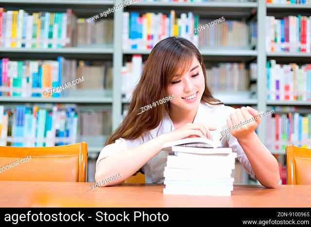 young beautiful asian girl in school library