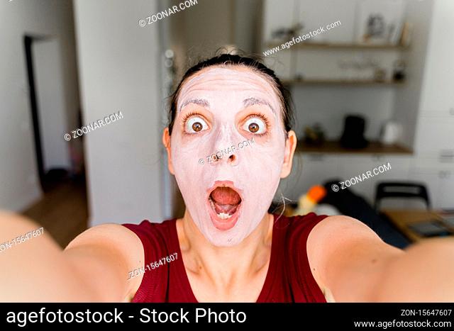 Caucasian woman with face mask live streaming as a beauty blogger. High quality photo