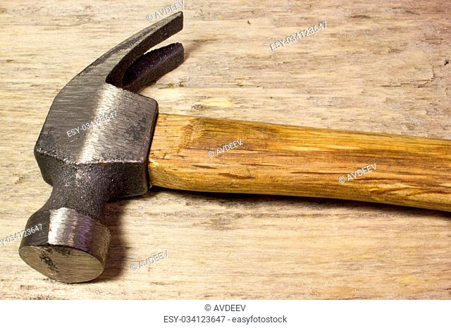 Hammer on wooden background
