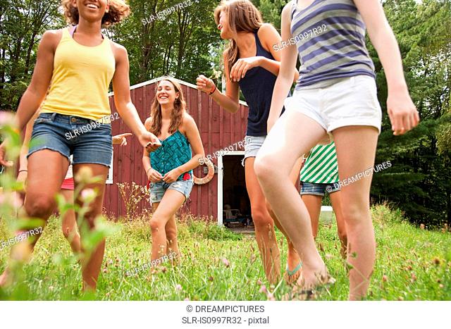 Teenage girls walking and having fun together in countryside