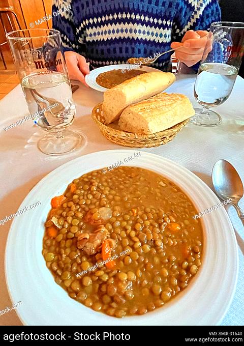 Eating lentils stew. Spain