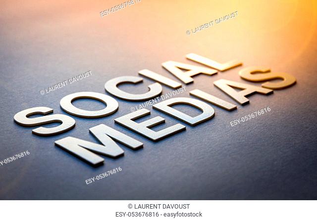 Word social medias written with white solid letters on a board