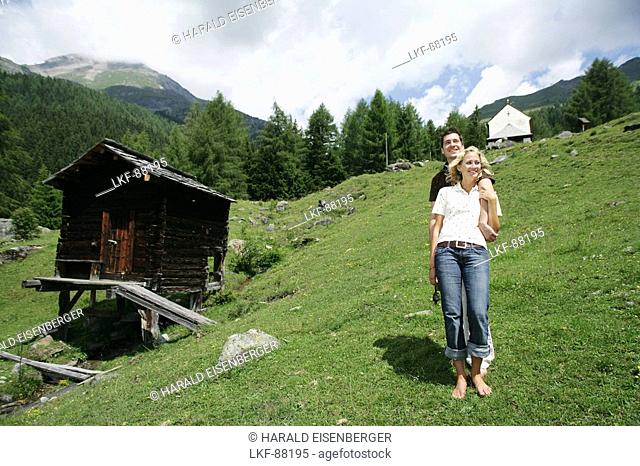 Young couple on alp, Heiligenblut, Hohe Tauern National Park, Carinthia, Austria