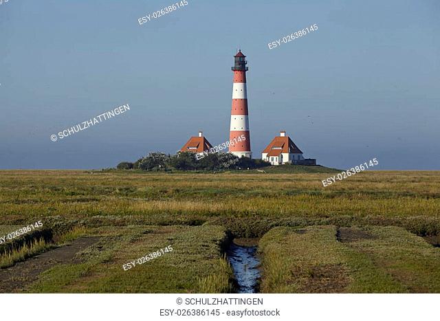 Landscape with salt meadows anad the light house Westerhever located near the coast of the North Sea taken on a sunny morning