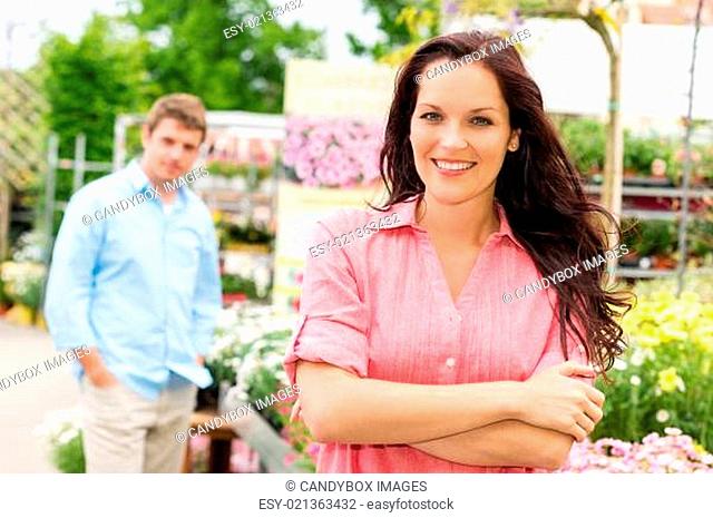 Smiling woman standing at garden center