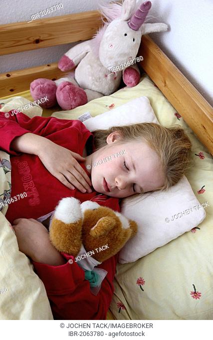 Girl, 10 years old, is ill in bed with a cold, flu, fever