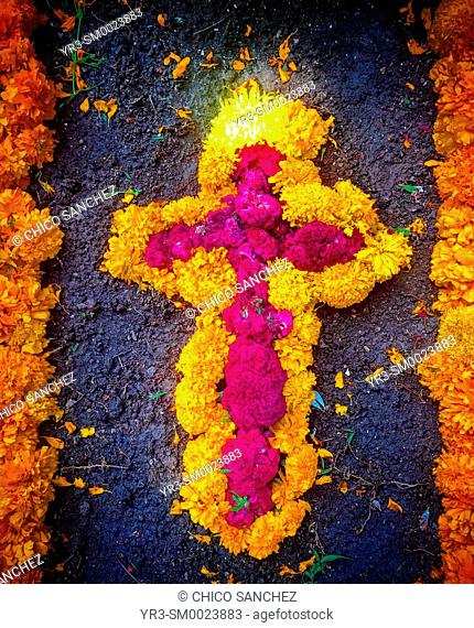 A cross made of marigold flowers decorates a tomb during Day of the Dead celebrations in San Gregorio Atlapulco, Mexico City, Mexico