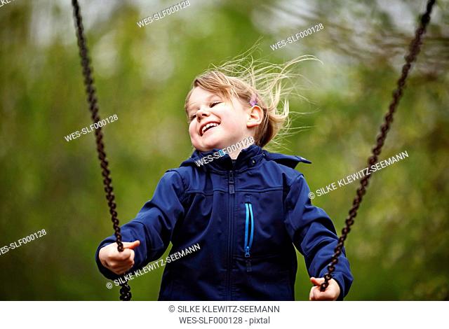 Germany, Baden Wuerttemberg, Girl swinging on swing