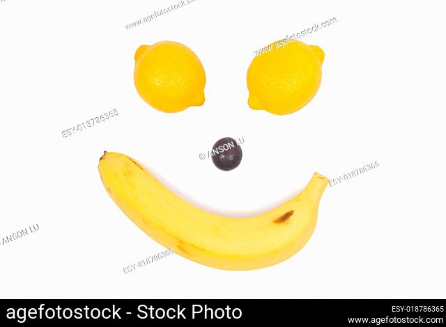 Fruit like man's face. Lemon, banana and grape