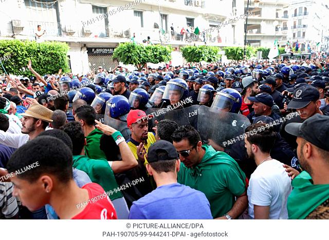 05 July 2019, Algeria, Algiers: Algerians scuffle with security forces during a march calling for the departure of the Algerian regime coinciding with the...