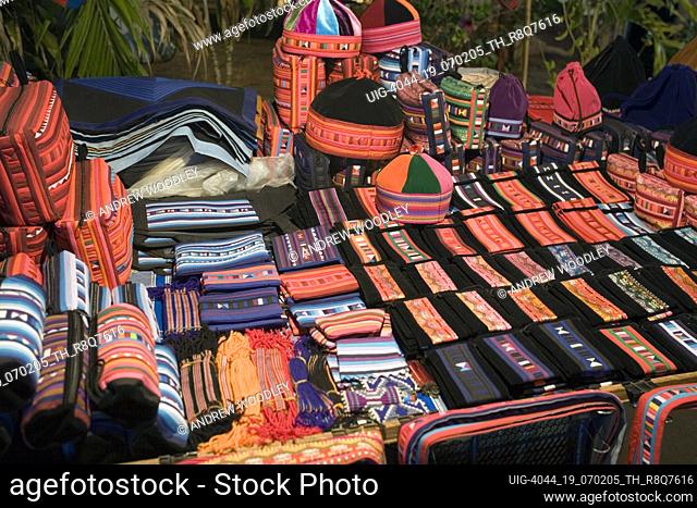 Colourful Lisu hill tribe hats bags and woven craft souvenirs road side stall Mae Hong Son night market north Thailand