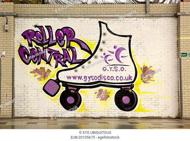 Former parcel delivery warehouse converted into roller disco with the walls decorated by local graffiti artists. Skate painted on wall advertising GYSO