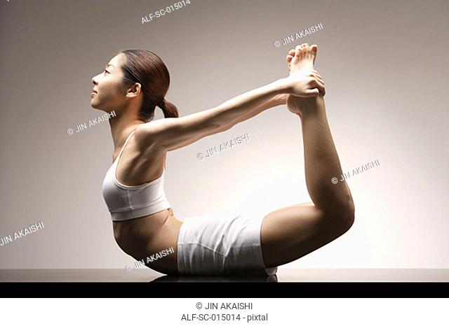 Young Asian woman in yoga position
