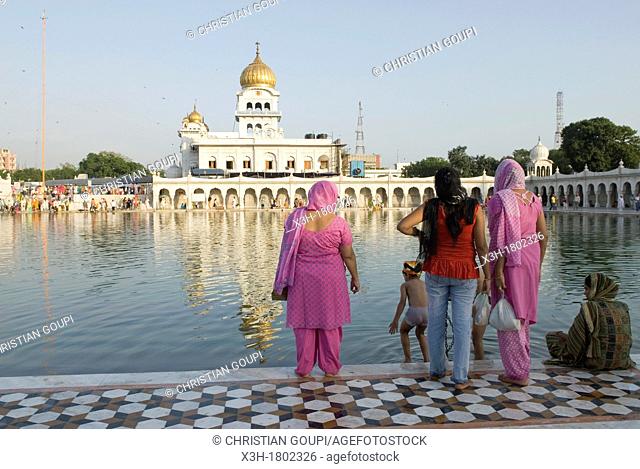 followers by the ' Sarovar' pond whose water is considered holy, inside Gurudwara Bangla Sahib, the most prominent Sikh gurdwara, or Sikh house of worship