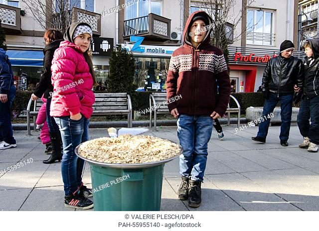 Florian, 12 (r) sells pumpkin seeds with his younger cousin February 17, 2015 in downtown Pristina (Kosovo). He works when he is not in school in order to...