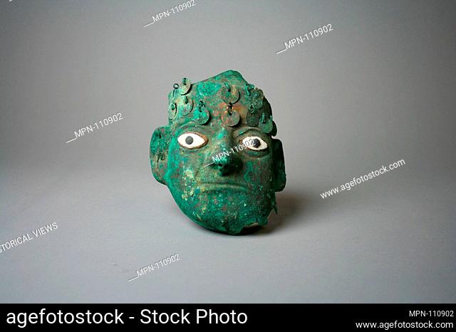 Face Mask Ornament. Date: 390-450; Geography: Peru; Culture: Moche (Loma Negra); Medium: Silvered copper, shell; Dimensions: H x W: 4 5/16 x 3 3/4in