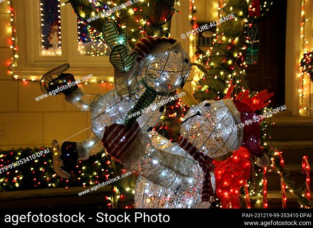 18 December 2023, USA, New York: Decorated snowmen in front of a house decorated for Christmas in Dyker Heights. As Christmas approaches