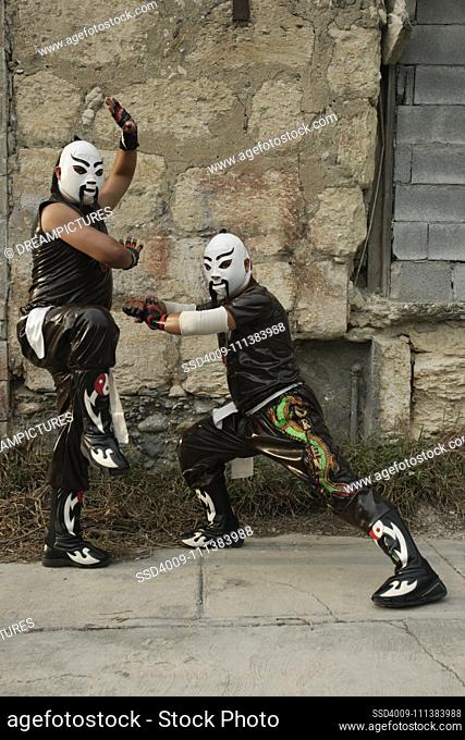 Hispanic men dressed as Mexican wrestlers