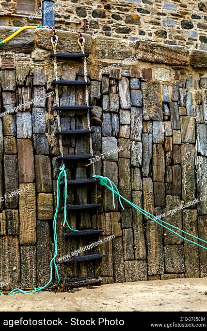 Rope ladder from jetty down into harbour. At low tide. Portsoy Banffshire Scotland UK