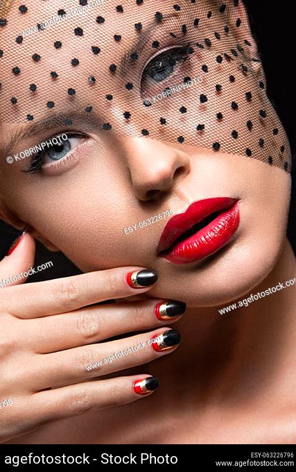 Beautiful girl with a veil, evening makeup, black and red nails. Design manicure. Beauty face. Picture taken in the studio