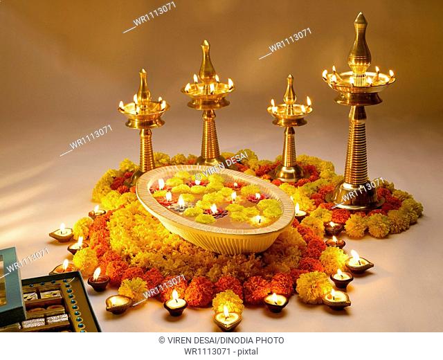 Diyas oil lamps and flowers arrangement for diwali festival ; India