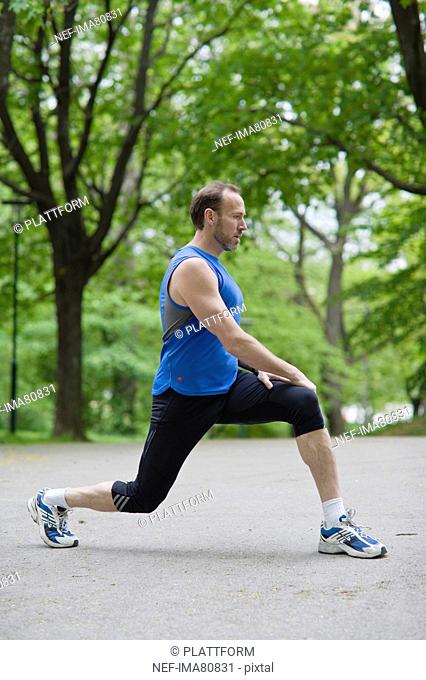 Man stretching in park