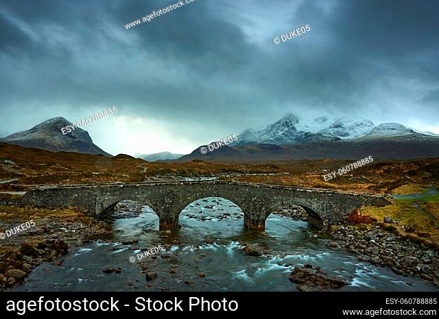 Old three arched stone bridge over the River Sligachan in Isle of Skye Scotland with Cuillin mountain range in the distance, Isle of Skye, Scotland