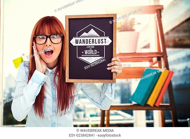 Composite image of smiling hipster woman holding blackboard