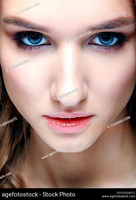Closeup macro shot of human woman face. Female with smoky eyes makeup