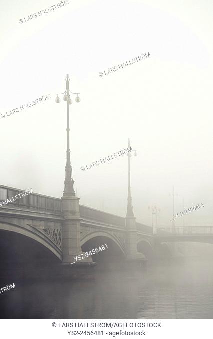 Empty bridge in heavy fog. Tranquil city scene with old architecture in Stockholm, Sweden