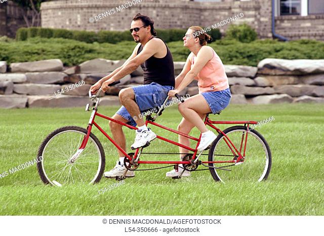 Couple ride a tandem bicycle