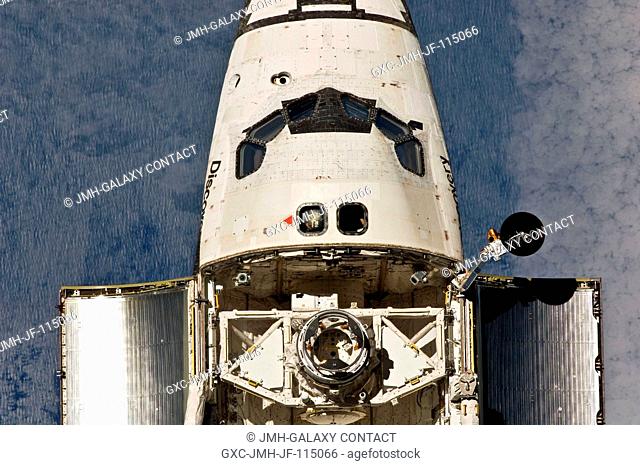 This view of the crew cabin and forward payload bay of the space shuttle Discovery was provided by an Expedition 26 crew member during a survey of the...