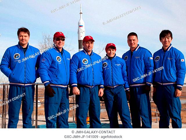 Behind the Cosmonaut Hotel crew quarters in Baikonur, Kazakhstan, the Expedition 4243 prime and backup crewmembers pose for pictures Nov