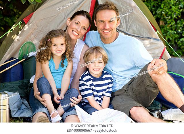 Adorable family camping in the garden