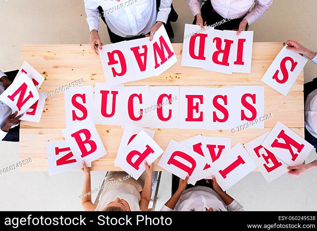 Multi-ethnic group of diverse people putting letters success teamwork cooperation concept