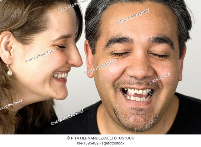 Close-up of mature couple laughing  Wrinkles and stubble are visible