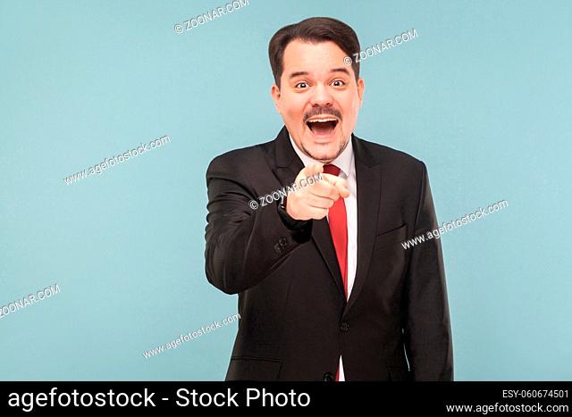 man with funny situation or a video in an faile army and it made him laugh. indoor studio shot. isolated on light blue background