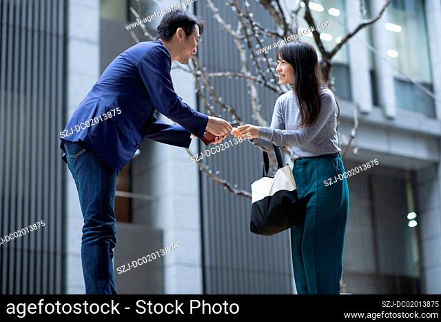 Businessman and woman exchanging business card
