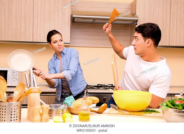 Young family doing funny fight at kitchen