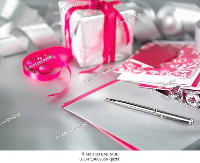 Christmas gifts with ribbon, pen and card