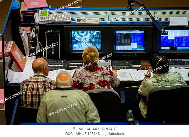 Russian flight controllers at the Russian Mission Control Center in Korolev, Russia monitor the Soyuz TMA-04M as it docks to the International Space Station on...
