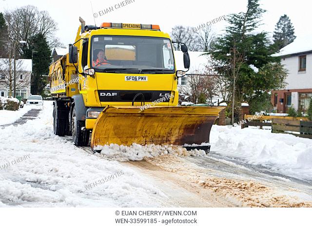 Sourthern Scotland suffers heavy snow overnight, as much as 8cm fell in the borders. A gritter makes it way through suburbia in Moffat