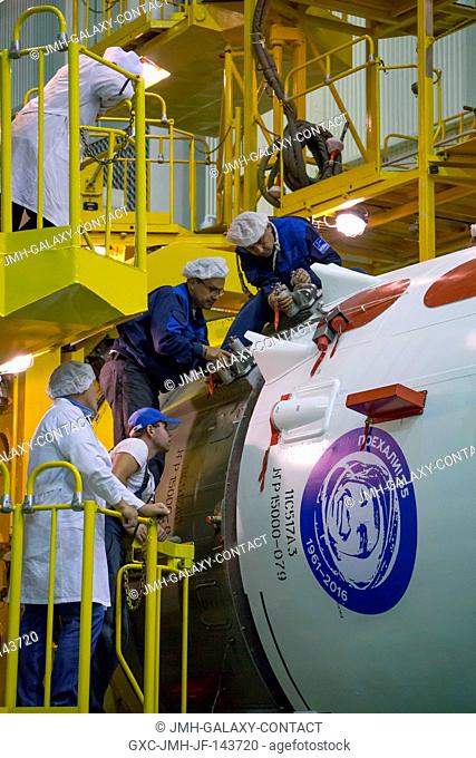 Workers monitor the encapsulation of the Soyuz MS-02 spacecraft in its fairing on Thursday, Tuesday, Oct. 11, 2016 at the Baikonur Cosmodrome in Kazakhstan